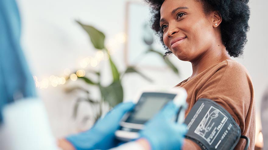 Woman getting a blood pressure check at doctor's office